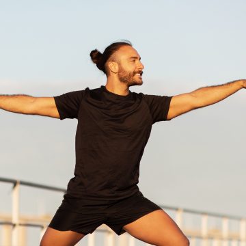 sporty-man-striking-yoga-asana-standing-in-warrior-2023-11-27-05-21-08-utc-1.jpg